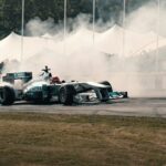A man driving a race car on top of a race track