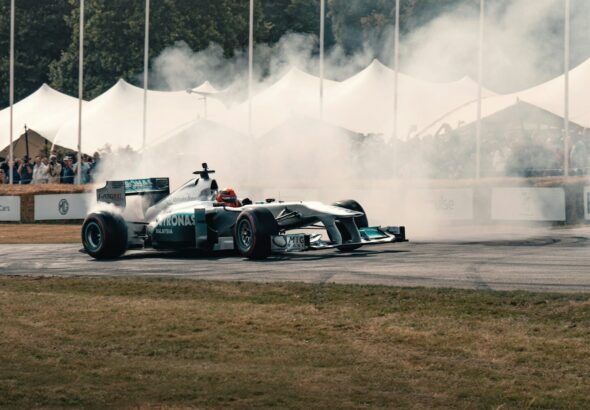 A man driving a race car on top of a race track