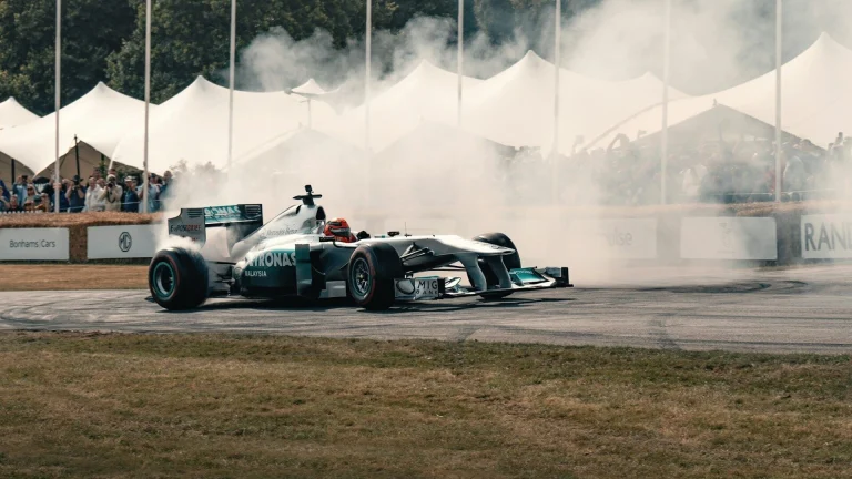 A man driving a race car on top of a race track