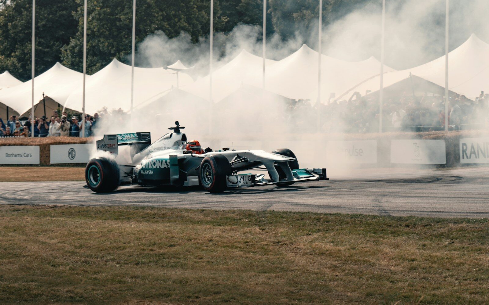 A man driving a race car on top of a race track