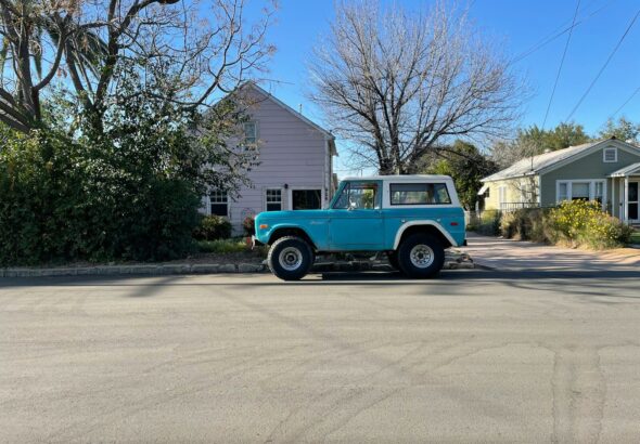 blue and white single cab truck parked near bare trees during daytime