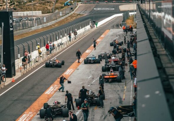 a group of people around a race car on a track