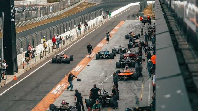 a group of people around a race car on a track