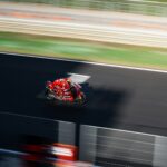 a person riding a motorcycle on a race track