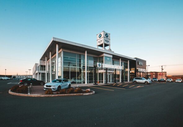 different vehicles near glass walled building
