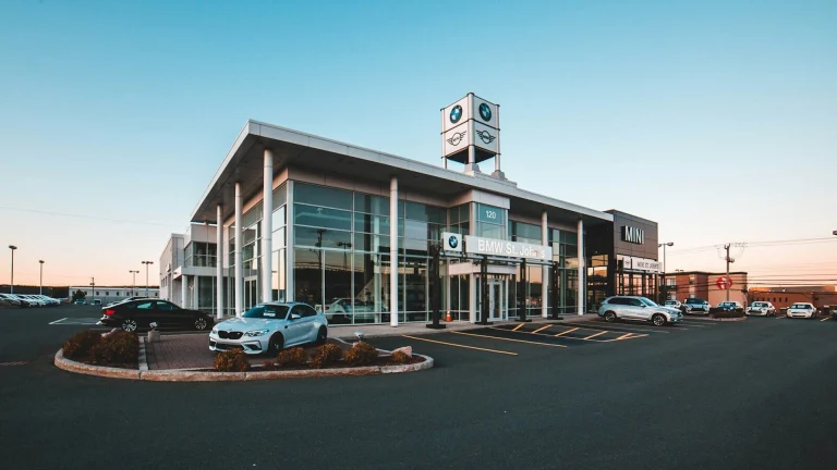 different vehicles near glass walled building