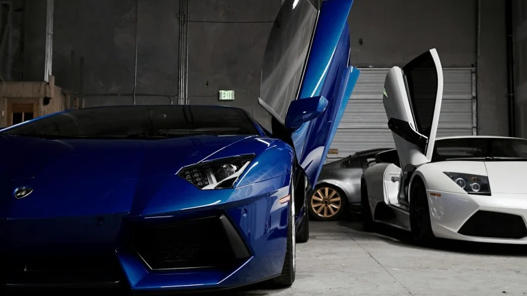 two white and blue Lamborghini vehicles inside garage