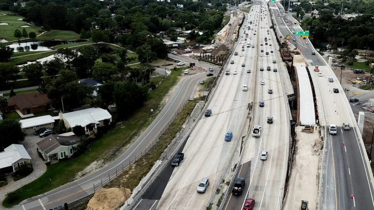 an aerial view of a highway with a train on it