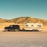 black SUV and white trailer