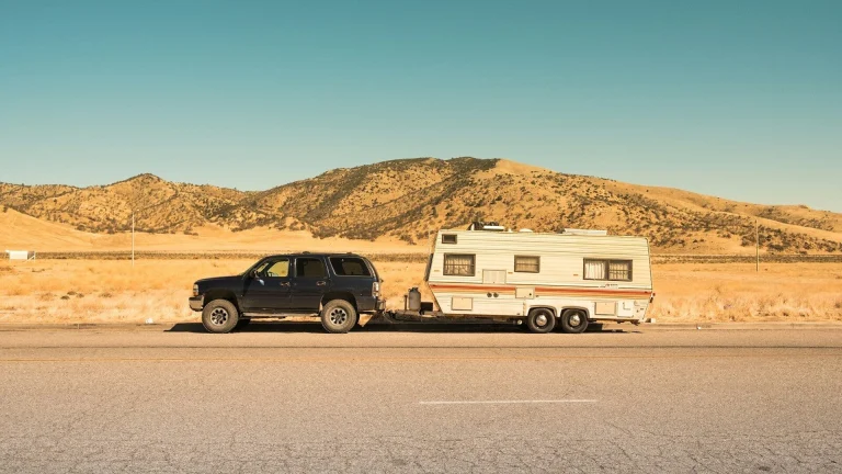 black SUV and white trailer