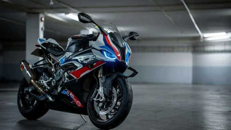 a red, white, and blue motorcycle parked in a parking garage