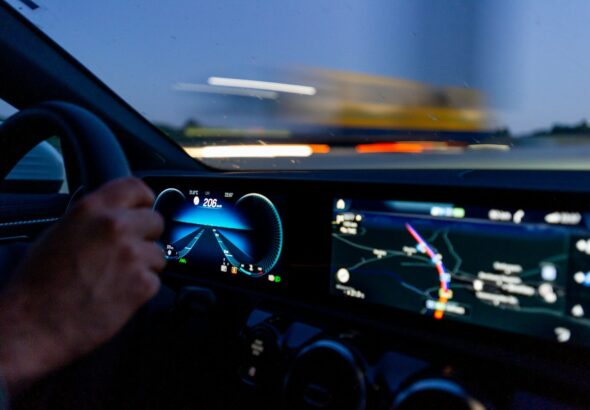 person's hand on steering wheel