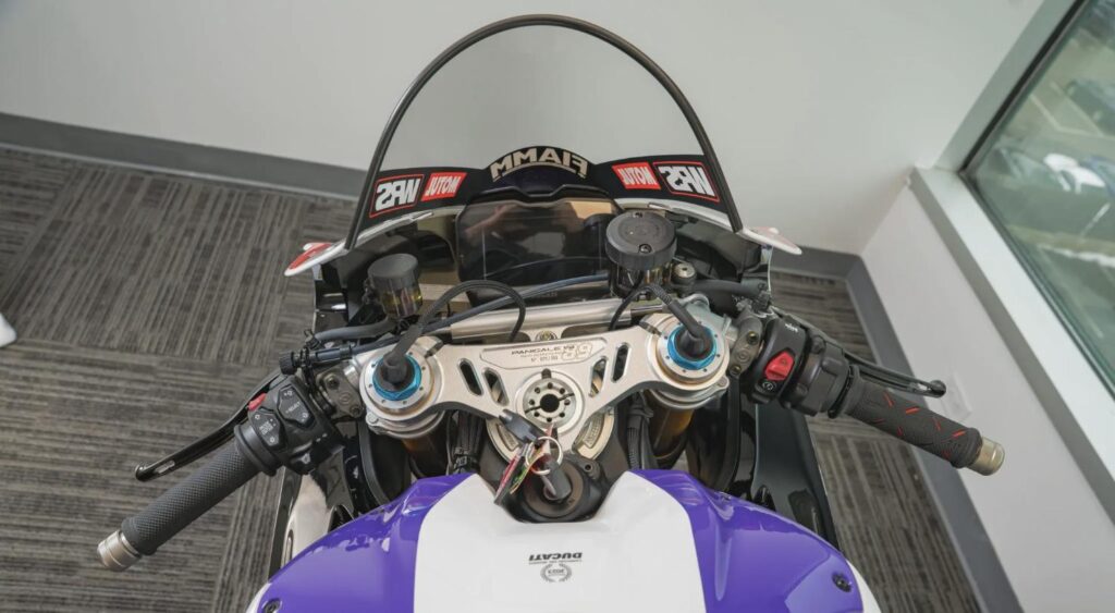 Cockpit view of the Ducati Panigale V4 racing replica showing clip-ons and windscreen