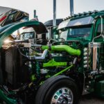 a close up of the front of a green semi truck