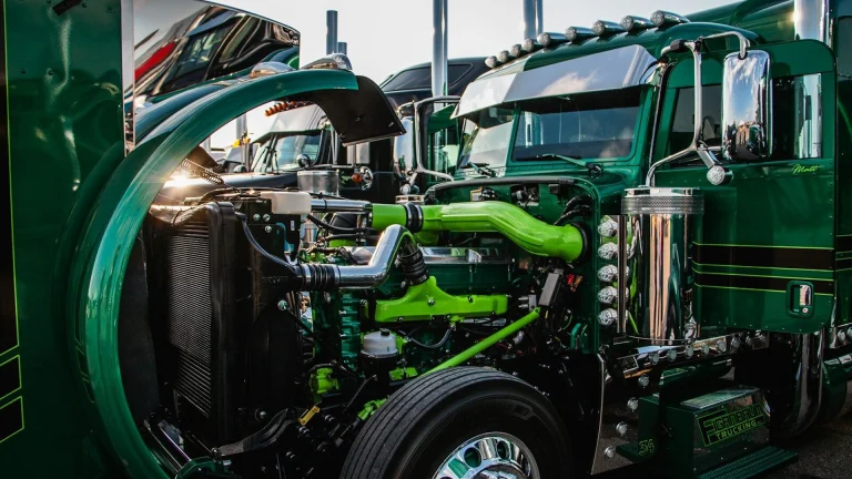 a close up of the front of a green semi truck