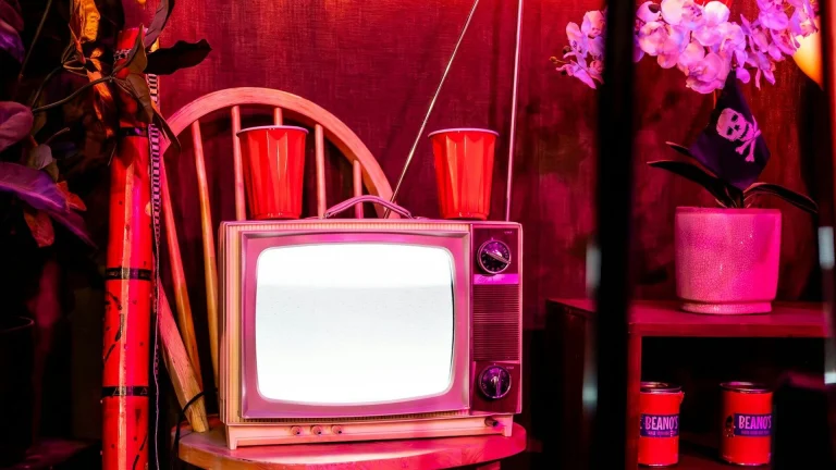 A television set sitting on top of a wooden stand