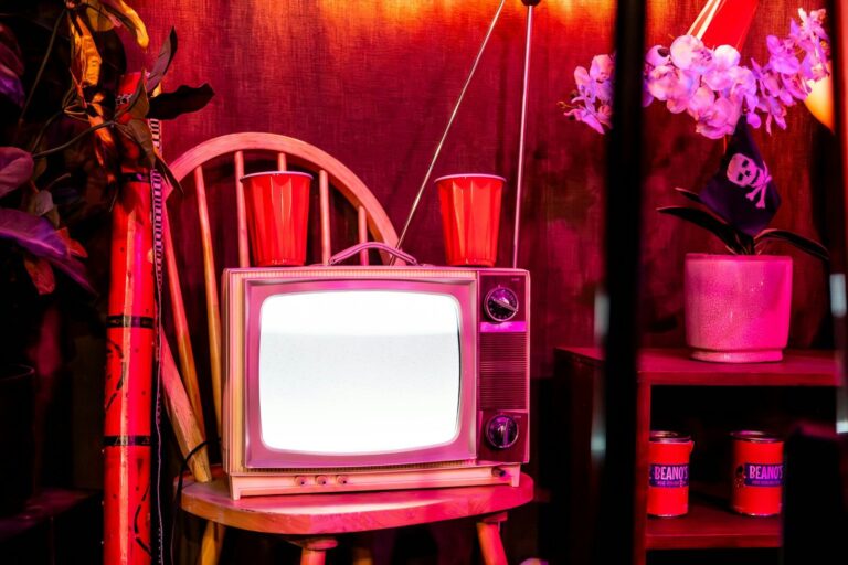 A television set sitting on top of a wooden stand