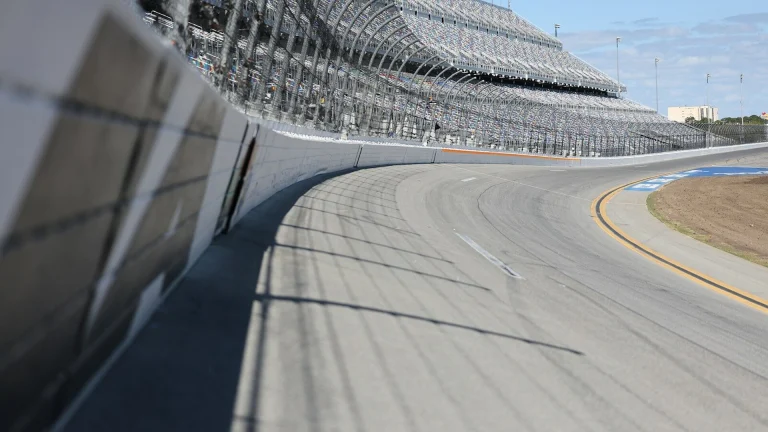 A racetrack curve and grandstands are shown.