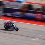 a person riding a motorcycle on a race track