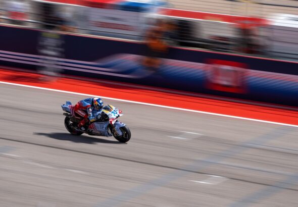 a person riding a motorcycle on a race track