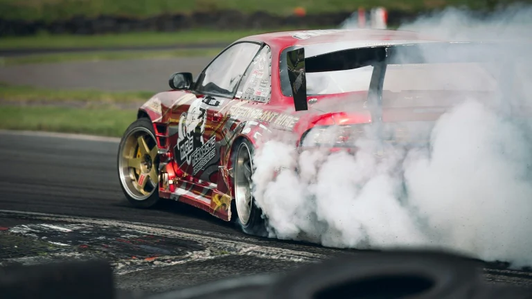 red and white ferrari f 1 on track