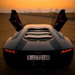 closeup photo of gray coupe on desert