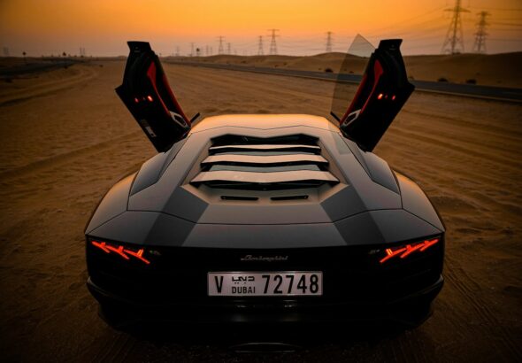 closeup photo of gray coupe on desert