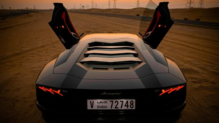 closeup photo of gray coupe on desert
