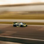 a car driving down a race track in motion