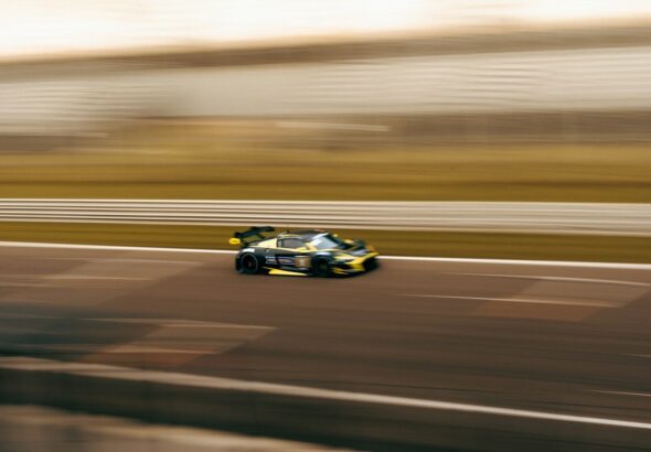 a car driving down a race track in motion