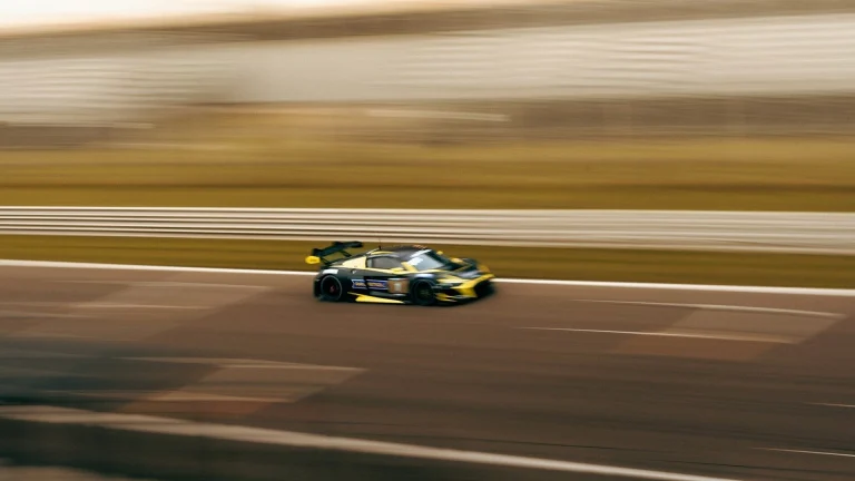 a car driving down a race track in motion