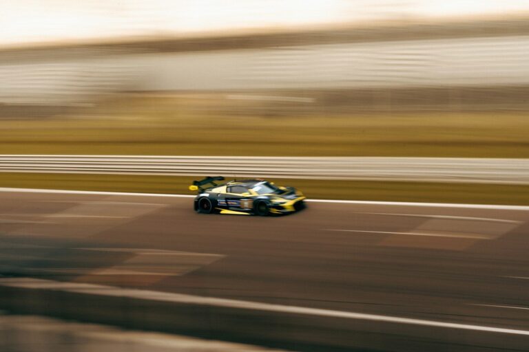 a car driving down a race track in motion