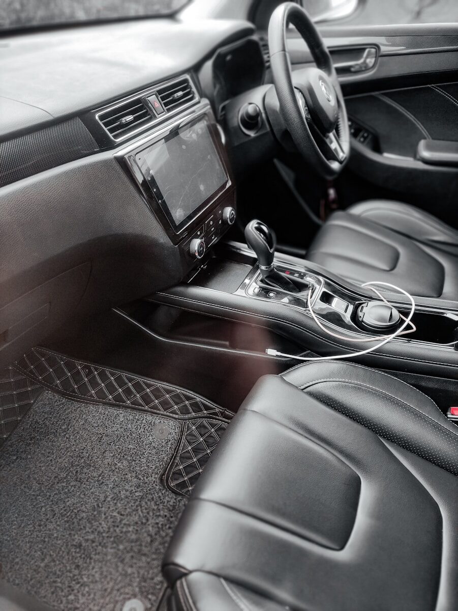 the interior of a car with black leather seats