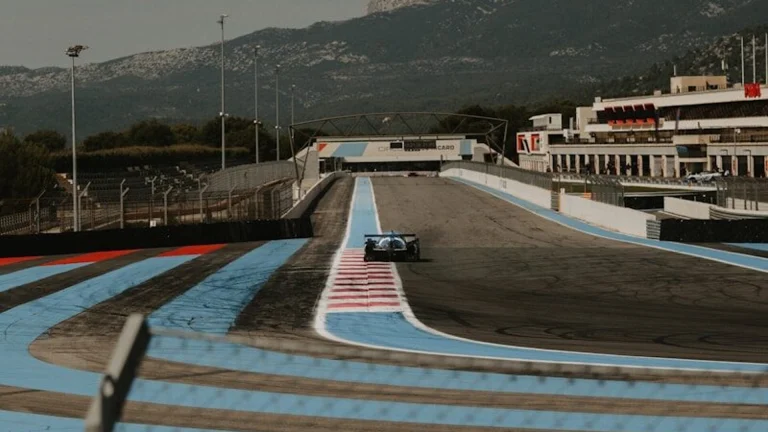 A race track with a boat in the background