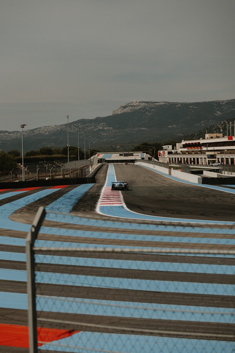 A race track with a boat in the background