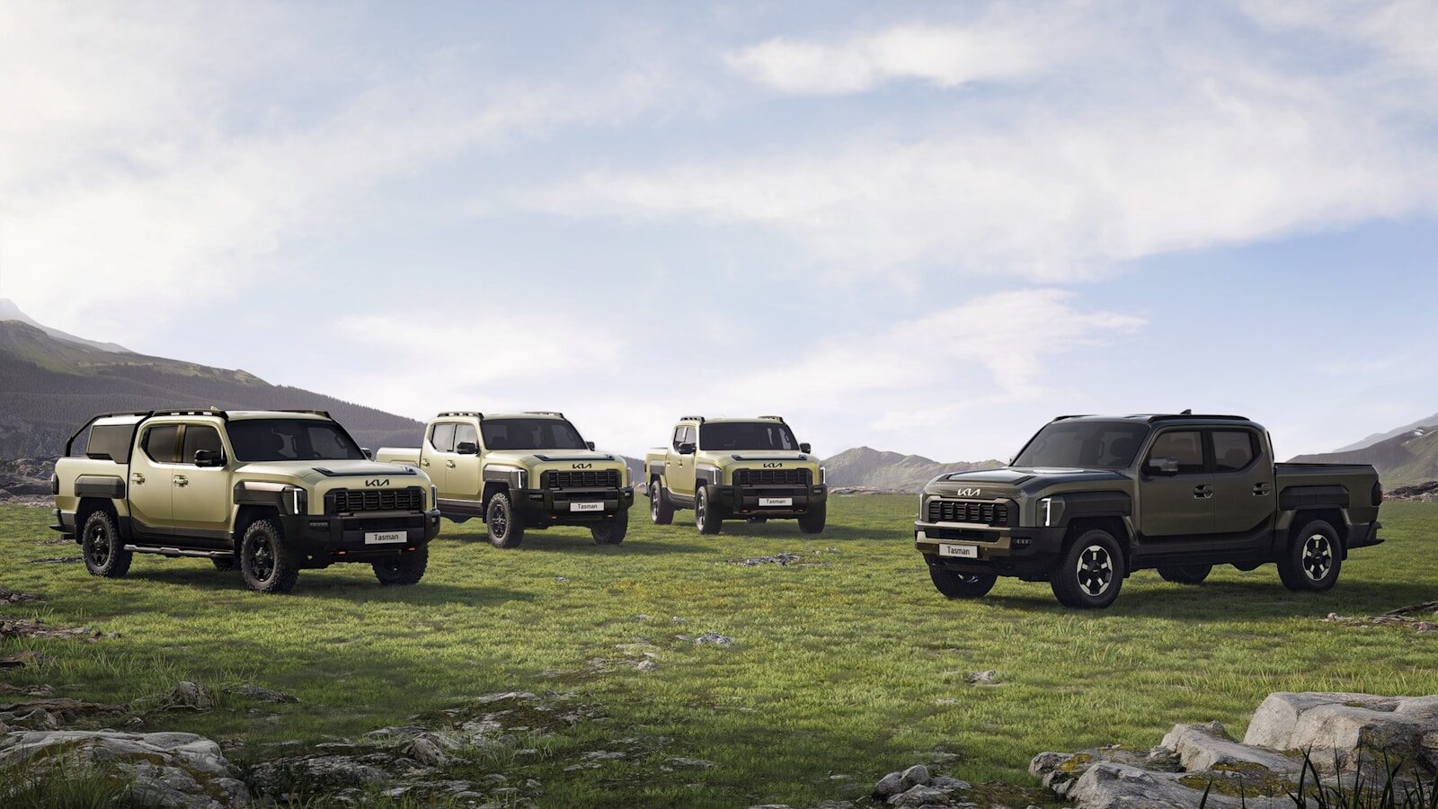 A group of four trucks parked in a field
