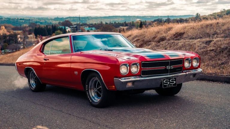 red chevrolet camaro on road during daytime