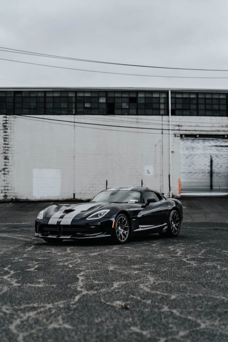a black sports car parked in a parking lot