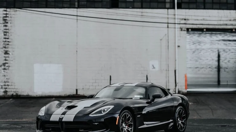 a black sports car parked in a parking lot