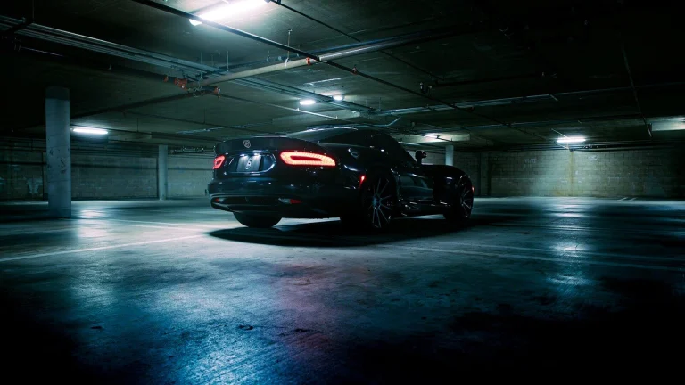 A black car parked in a parking garage