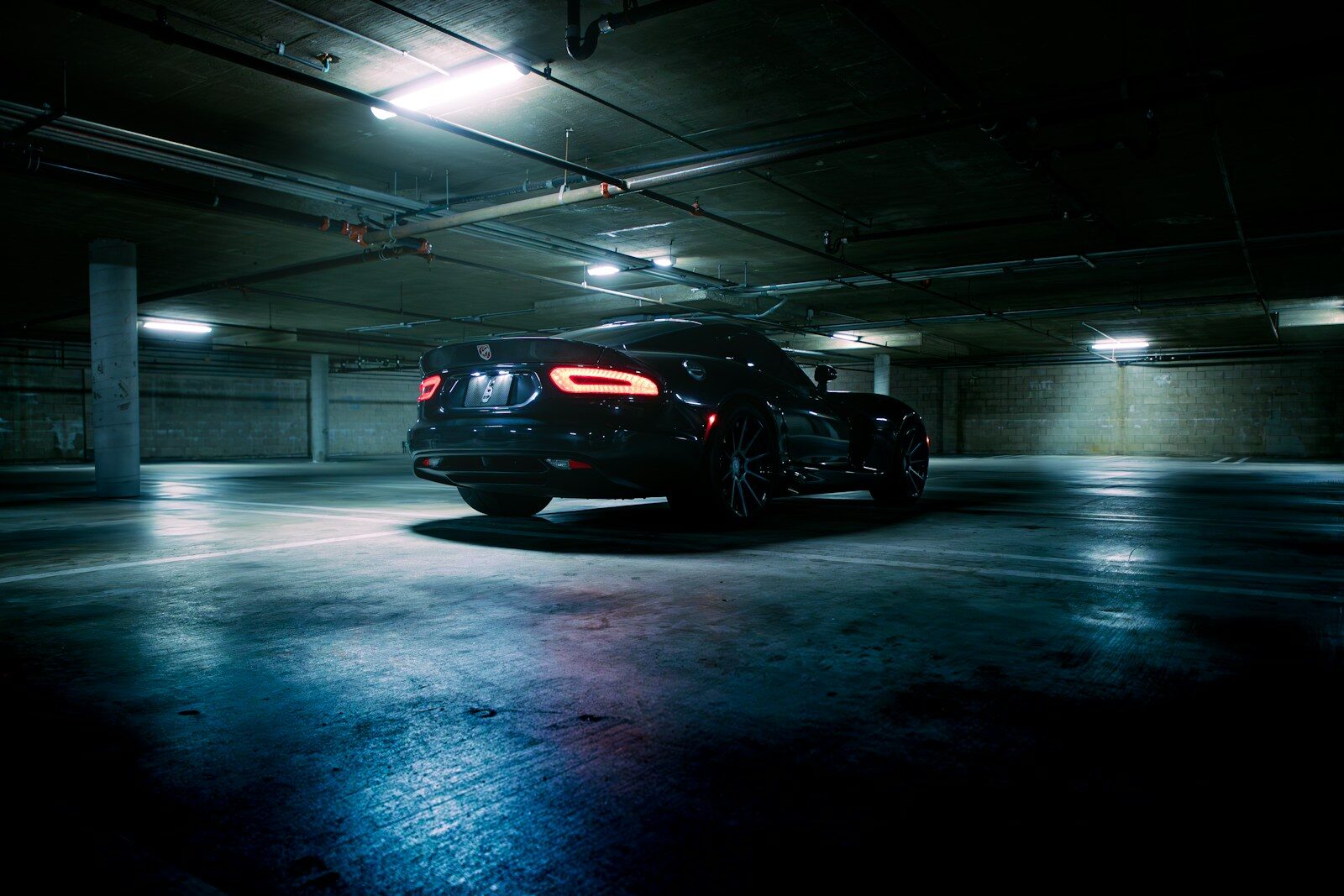 A black car parked in a parking garage
