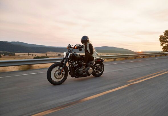 man on black cruiser motorcycle in highway