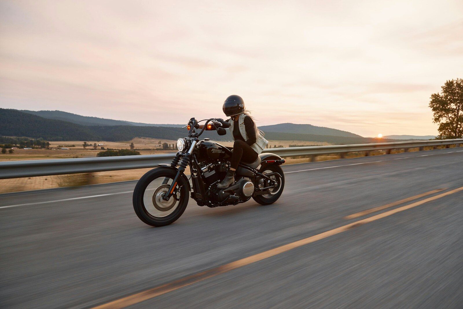 man on black cruiser motorcycle in highway