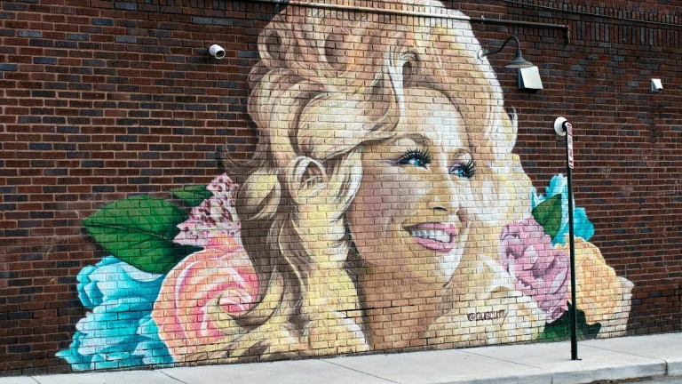 woman and girl painting on wall