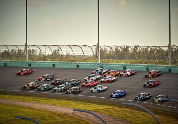 NASCAR Cup Series stock cars racing side by side on track