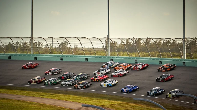 NASCAR Cup Series stock cars racing side by side on track