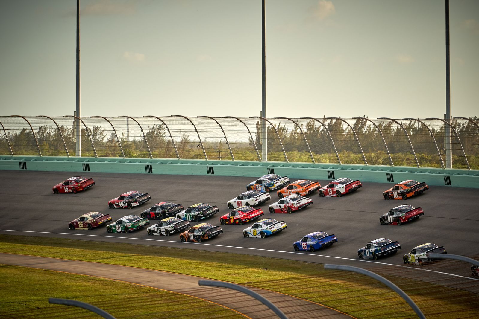 NASCAR Cup Series stock cars racing side by side on track