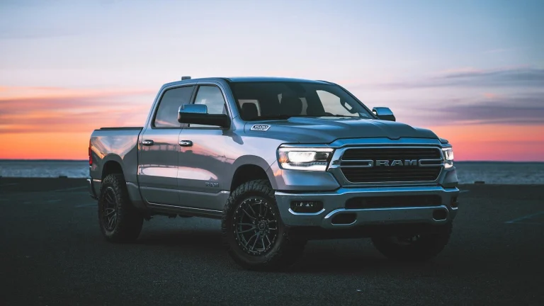 a silver ram truck parked in a parking lot