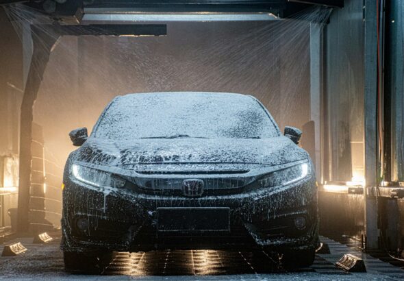 a car is covered in snow in a garage