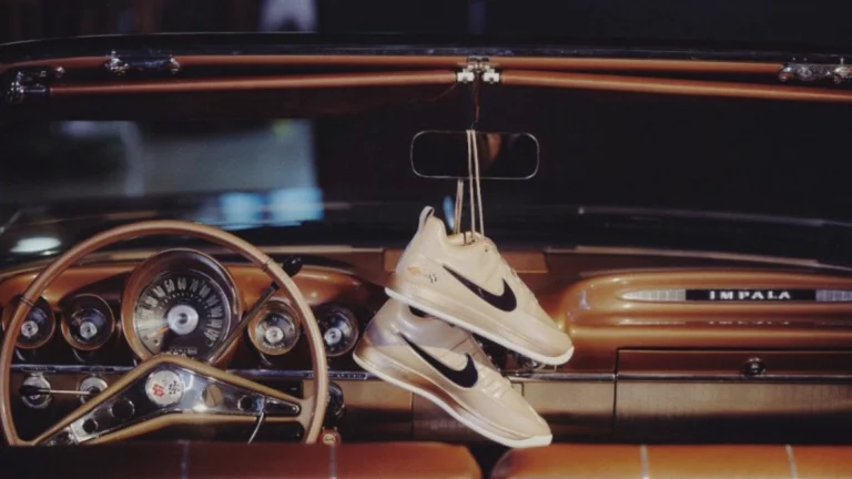 Nike Book 2 "Pretty Penny" sneakers hanging from the rearview mirror of Devin Booker's 1959 Chevrolet Impala convertible